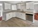 Bright kitchen with stainless steel appliances, white cabinets, and granite countertops at 6367 Deshong Dr, Lithonia, GA 30058