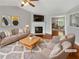 Cozy staged living room with fireplace, neutral walls, and view of an open-plan dining room at 6367 Deshong Dr, Lithonia, GA 30058