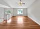 Open-concept living room with hardwood floors and a staircase featuring a white railing at 6367 Deshong Dr, Lithonia, GA 30058