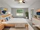 Staged main bedroom with neutral walls and a ceiling fan at 6367 Deshong Dr, Lithonia, GA 30058
