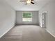 Spacious main bedroom with neutral walls, large windows, and carpet at 6367 Deshong Dr, Lithonia, GA 30058