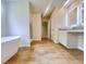 A luxurious bathroom features a freestanding tub, a shower, and double vanity at 679 Egrets Landing Lot 57, Covington, GA 30014