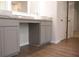 Bathroom vanity featuring dual sinks, granite countertop, and wood-look tile flooring at 679 Egrets Landing Lot 57, Covington, GA 30014