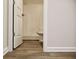 Neat bathroom featuring a toilet and a shower with white walls and wood-look floor at 679 Egrets Landing Lot 57, Covington, GA 30014