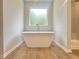 An elegant bathroom features a stand-alone tub and glass shower at 679 Egrets Landing Lot 57, Covington, GA 30014