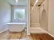 A modern bathroom features a stand-alone tub and glass shower at 679 Egrets Landing Lot 57, Covington, GA 30014