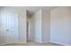 This bedroom features neutral carpet, white walls, and a white door, creating a calm and inviting space at 679 Egrets Landing Lot 57, Covington, GA 30014