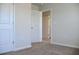 Bright bedroom with neutral carpet, white walls, and white door trim, offering a cozy and comfortable atmosphere at 679 Egrets Landing Lot 57, Covington, GA 30014