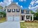 Charming two-story brick home featuring a two-car garage and inviting front porch at 679 Egrets Landing Lot 57, Covington, GA 30014