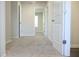 Hallway with neutral carpet and doors, connecting different parts of the home at 679 Egrets Landing Lot 57, Covington, GA 30014