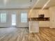 Bright kitchen features stainless steel appliances, a granite countertop island, and an adjacent dining area with large windows at 679 Egrets Landing Lot 57, Covington, GA 30014