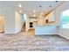 Open-concept kitchen with modern appliances, white cabinets, and hardwood floors, creating a seamless living space at 679 Egrets Landing Lot 57, Covington, GA 30014