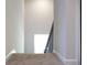 Carpeted staircase leading up, offering a bright and airy feel with natural light at 679 Egrets Landing Lot 57, Covington, GA 30014