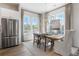 Elegant dining area featuring hardwood floors, stainless steel appliances, and natural light from large windows at 962 Bibbs Nw Cir # 8, Atlanta, GA 30318