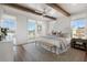 Bright bedroom featuring wooden beam ceiling, hardwood floors, and large windows with a scenic view at 962 Bibbs Nw Cir # 8, Atlanta, GA 30318