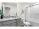 Bright bathroom with granite countertop, modern fixtures, and a combined tub and shower at 11569 Kimberly Way # 26, Hampton, GA 30228