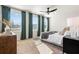 Bright bedroom with three large windows and green curtains, features a daybed and modern furniture at 11569 Kimberly Way # 26, Hampton, GA 30228