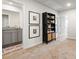 Hallway featuring a view into a bathroom, linen closet, and pictures at 11569 Kimberly Way # 26, Hampton, GA 30228