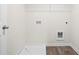 A functional laundry room with wood-look floors and essential hookups ready for appliances at 11569 Kimberly Way # 26, Hampton, GA 30228
