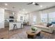 Open-concept living area with modern décor, pendant lighting, kitchen, and comfortable seating, ideal for entertaining at 11569 Kimberly Way # 26, Hampton, GA 30228