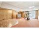 Finished basement with a bar area, exercise equipment, and wood paneling at 1316 Sanders Dr, Morrow, GA 30260