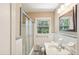 Bathroom featuring white tile, a glass-enclosed shower, and a modern marble vanity at 1316 Sanders Dr, Morrow, GA 30260