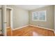 Neutral bedroom featuring hardwood floors, double windows, and a view of the tree canopy at 1316 Sanders Dr, Morrow, GA 30260