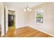 Charming dining room with hardwood floors, modern chandelier, and natural light from window at 1316 Sanders Dr, Morrow, GA 30260