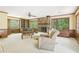 Spacious living room with a stone fireplace, built-in shelves, and large windows overlooking the backyard at 1316 Sanders Dr, Morrow, GA 30260