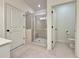 Bathroom featuring a glass-enclosed shower, tile floors, and neutral decor at 5515 Allegre Pl, Cumming, GA 30028