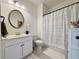 This bathroom offers a classic design, with a white vanity, toilet, and tub/shower combination at 5515 Allegre Pl, Cumming, GA 30028