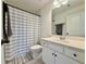 Clean bathroom featuring a tub, a shower with a striped curtain, and a vanity with sink at 5515 Allegre Pl, Cumming, GA 30028