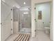 This bathroom features a walk-in shower with glass doors, neutral tile, and a separate toilet area at 5515 Allegre Pl, Cumming, GA 30028