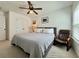 Comfortable bedroom with queen size bed, accent chair, and ample natural light from the windows at 5515 Allegre Pl, Cumming, GA 30028