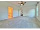 Large bedroom with plush carpeting and doorway into the bathroom at 5515 Allegre Pl, Cumming, GA 30028