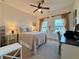 This bedroom features neutral decor, a ceiling fan, and multiple windows for ample natural light at 5515 Allegre Pl, Cumming, GA 30028