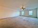 Spacious bedroom with carpet flooring, ceiling fan and natural lighting at 5515 Allegre Pl, Cumming, GA 30028