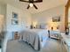 This bedroom features neutral decor, a ceiling fan, and a bright atmosphere, perfect for relaxation at 5515 Allegre Pl, Cumming, GA 30028