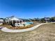 A beautiful community pool area with ample seating, landscaping, and clear blue water for summertime fun at 5515 Allegre Pl, Cumming, GA 30028