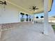 An inviting covered patio features a ceiling fan, stylish brick accents, and ample space for outdoor enjoyment and relaxation at 5515 Allegre Pl, Cumming, GA 30028