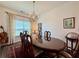 Elegant dining room featuring a chandelier, a large table with seating for six, and a rug at 5515 Allegre Pl, Cumming, GA 30028