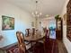 Traditional dining room showcasing a chandelier, a large wooden table, and hardwood floors at 5515 Allegre Pl, Cumming, GA 30028