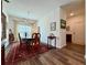 Formal dining room featuring a large wooden table with seating, a chandelier, and a colorful rug at 5515 Allegre Pl, Cumming, GA 30028