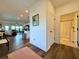 Open-concept entryway with hardwood floors leading to a modern kitchen and living area at 5515 Allegre Pl, Cumming, GA 30028