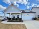 Charming single-story home with a covered porch, well-maintained landscaping, and attached two-car garage at 5515 Allegre Pl, Cumming, GA 30028