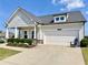Attractive home with a two-car garage, well-manicured lawn and attractive landscaping at 5515 Allegre Pl, Cumming, GA 30028