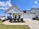 Charming single-story home with a two-car garage, inviting front porch, and well-manicured lawn at 5515 Allegre Pl, Cumming, GA 30028