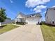 Charming home with a two-car garage, well-manicured lawn, and inviting front porch at 5515 Allegre Pl, Cumming, GA 30028