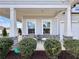 Inviting front porch seating area with stone accents, creating a cozy outdoor space at 5515 Allegre Pl, Cumming, GA 30028
