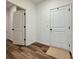 Hallway with hardwood floors and doors at 5515 Allegre Pl, Cumming, GA 30028